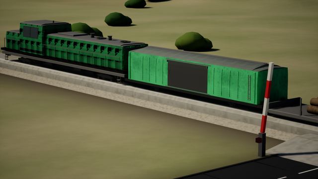 Green diesel locomotive and boxcar beside a level crossing barrier and road, close three-quarter view.